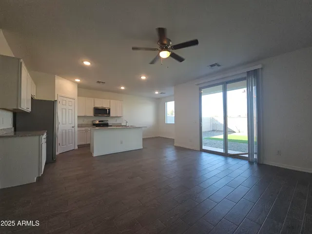 a view of kitchen with refrigerator and wooden floor