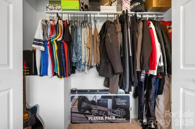 a view of walk in closet with clothes