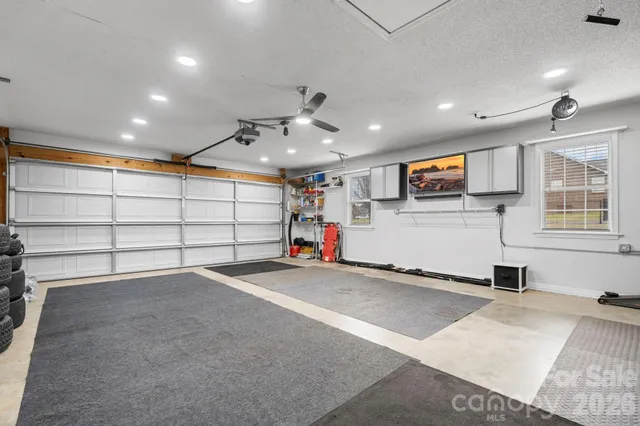 a view of a livingroom with fireplace and windows