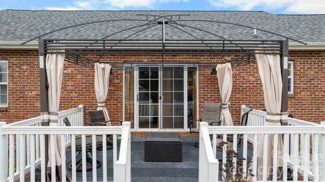 a backyard of a house with table and chairs