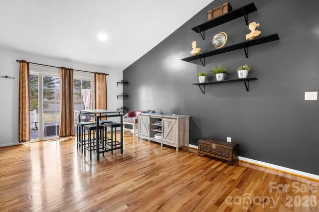a view of a livingroom with furniture wooden floor and windows