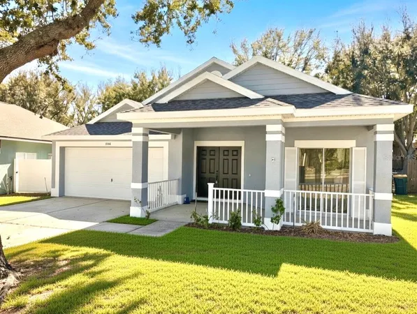 a front view of a house with a garden and yard