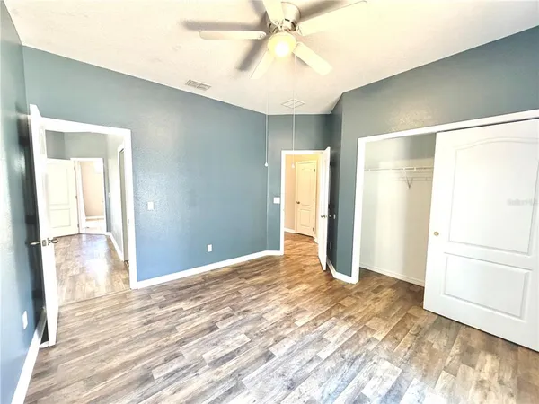 a view of an empty room with wooden floor