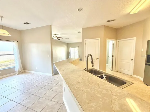 a large bedroom with a large bed and a chandelier