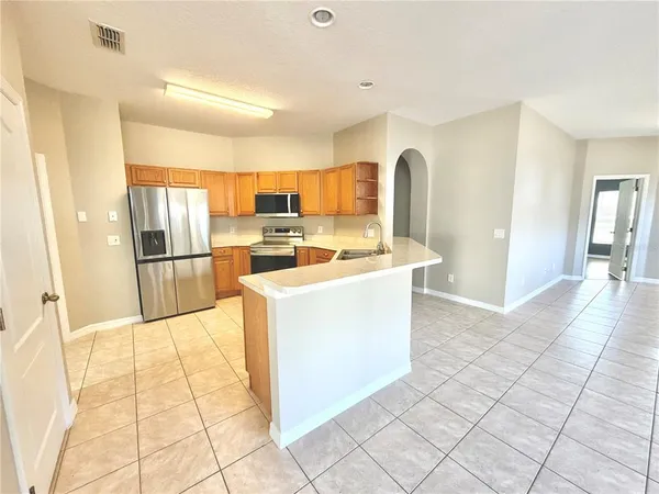 a kitchen with stainless steel appliances granite countertop a refrigerator and a sink