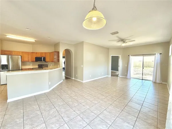 a view of a kitchen with sink and dishwasher with wooden floor