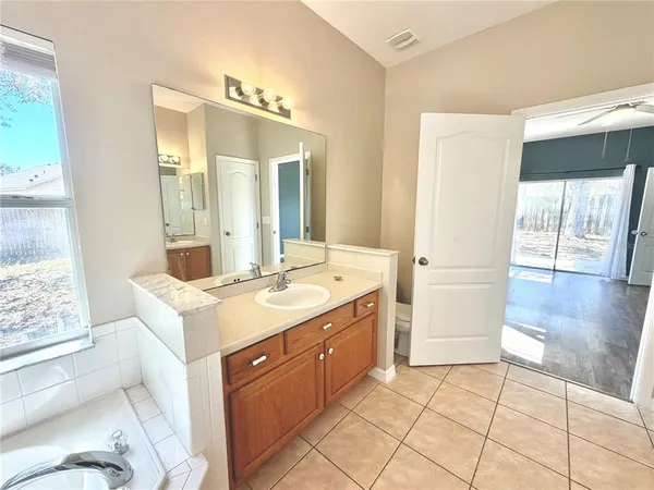 a bathroom with a sink a mirror and a shower