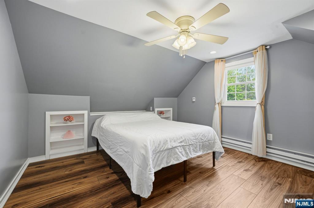 52 Barbara Drive Pompton Lakes, NJ 07442 - Photo 19 of 30 a bedroom with a bed and a chandelier