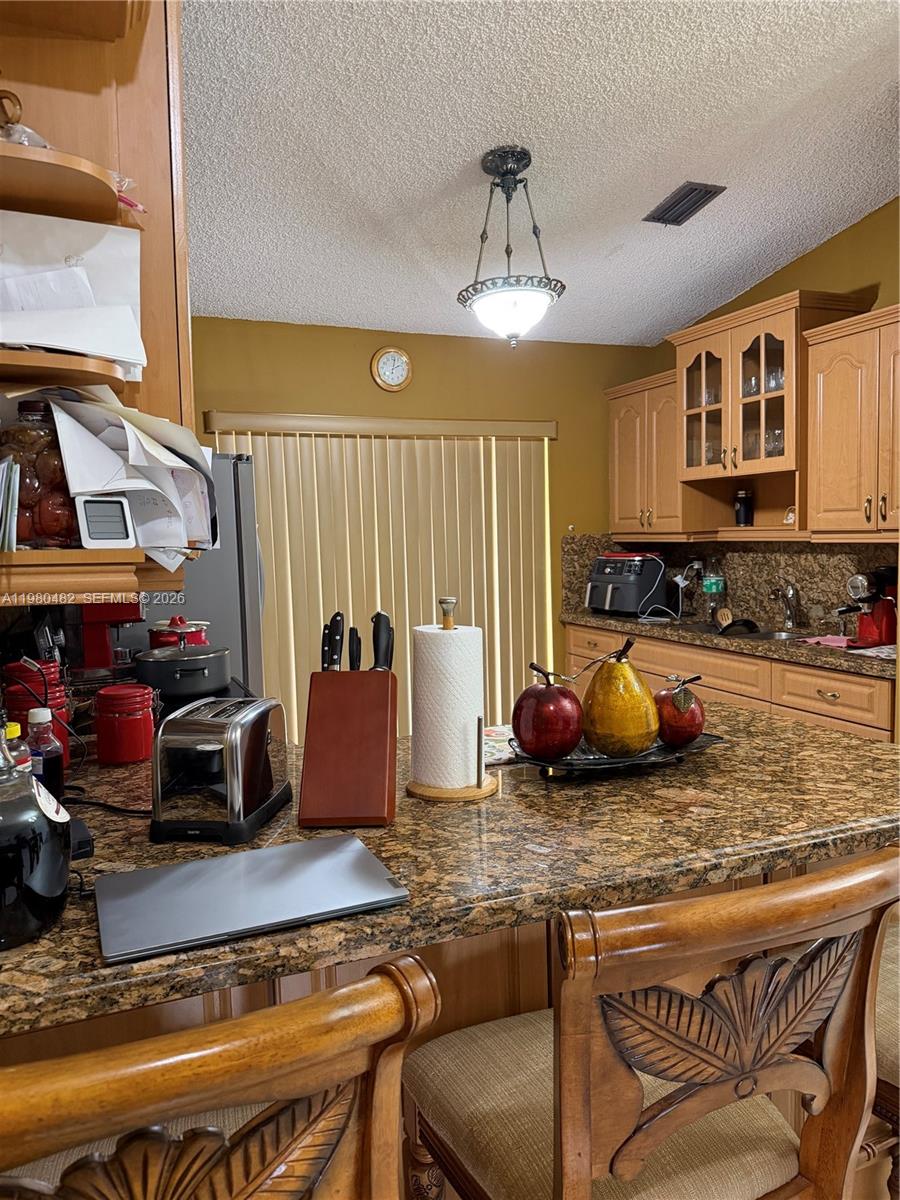 7792 West 29th Way, Unit 202 Hialeah, FL 33018 - Photo 4 of 14 a kitchen with a stove a sink and cabinets