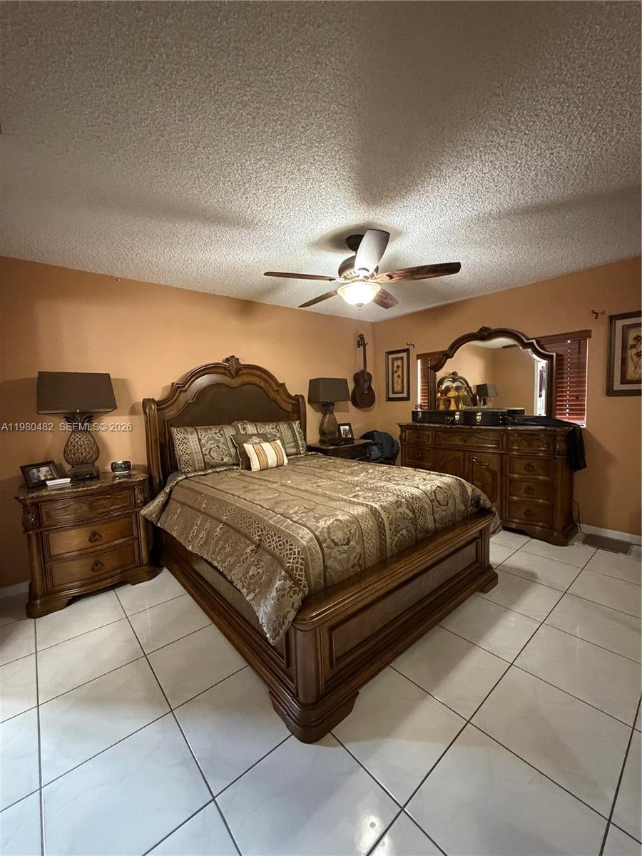 7792 West 29th Way, Unit 202 Hialeah, FL 33018 - Photo 5 of 14 a bedroom with a bed and dresser