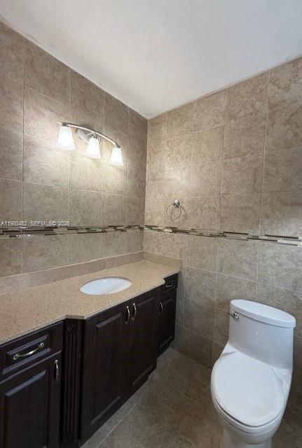 7792 West 29th Way, Unit 202 Hialeah, FL 33018 - Photo 6 of 14 a bathroom with a granite countertop toilet sink and mirror