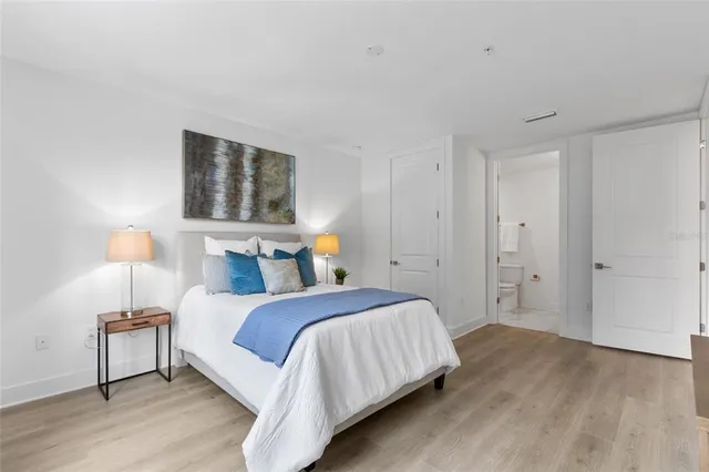 a bedroom with a bed and a night stand