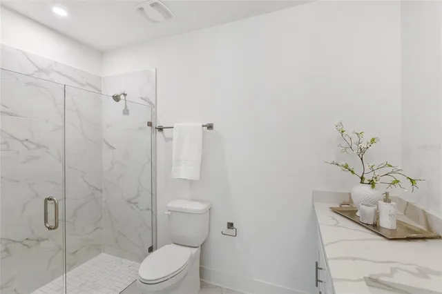 a bathroom with a toilet and shower