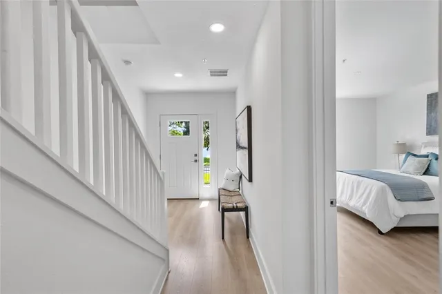 a view of a hallway with furniture and stairs