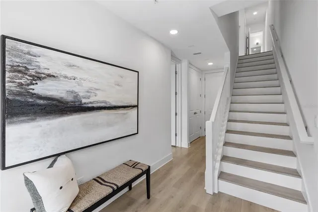 a view of entryway with stairs and wooden floor