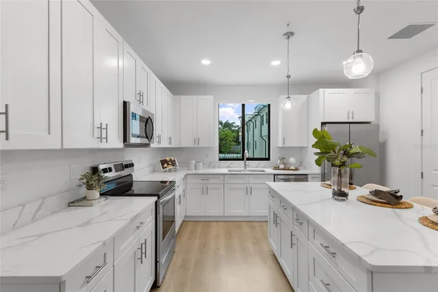 a kitchen with a sink stove and cabinets