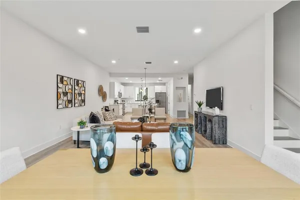 a dining room with lots of furniture and wooden floor