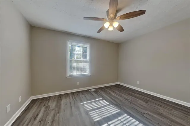 a bathroom with a granite countertop sink a toilet and shower