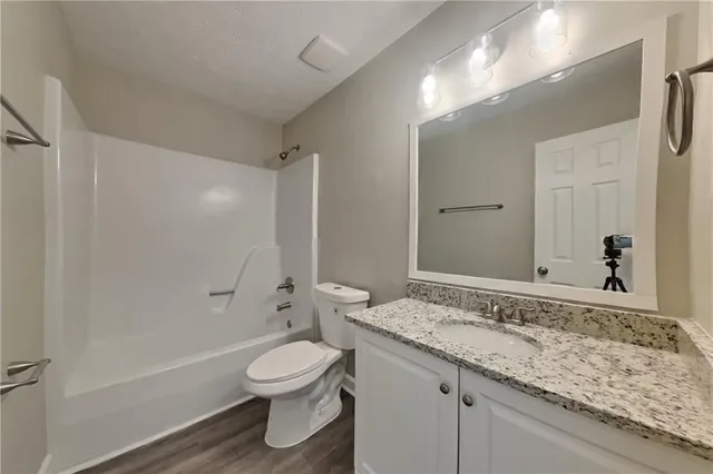 a view of a house with a yard and sitting area