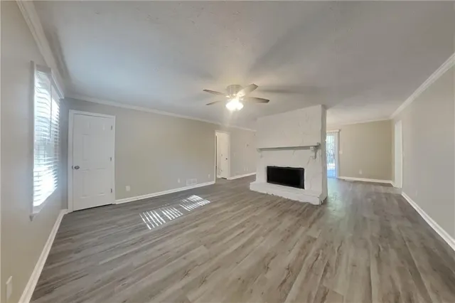 wooden floor in an empty room with a fireplace