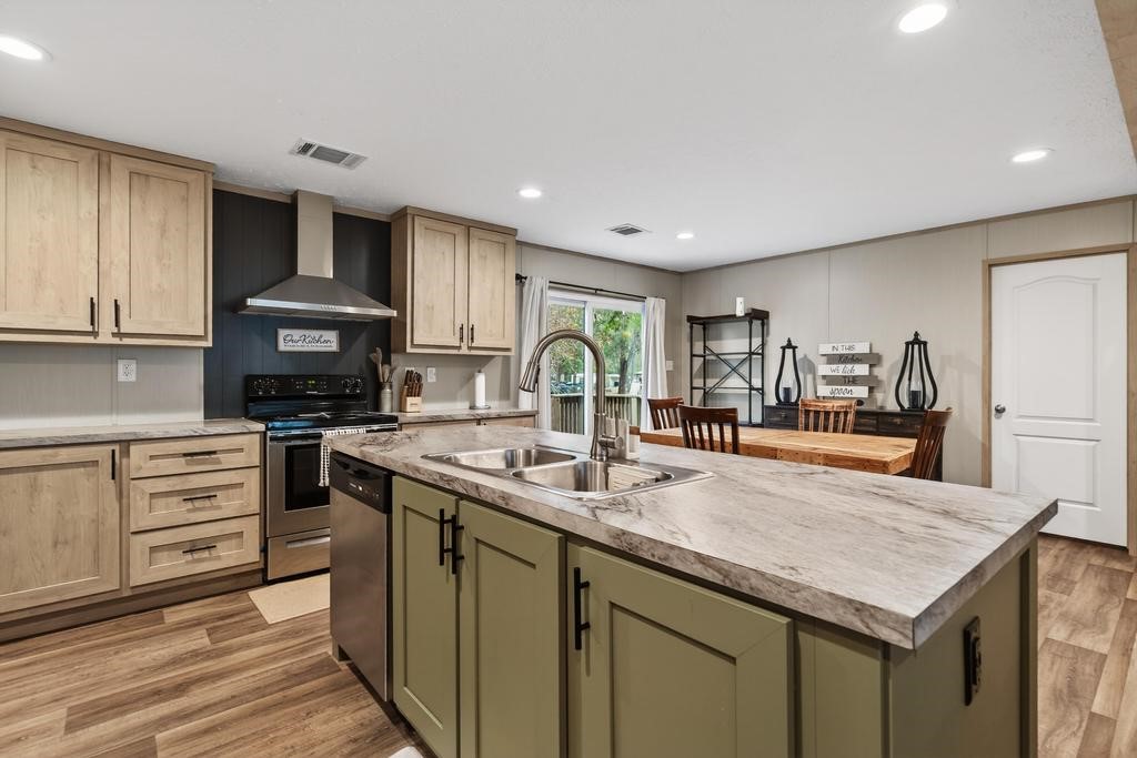 1088 Mulberry Landing Road Hilliard, FL 32046 - Photo 11 of 30 a kitchen with stainless steel appliances granite countertop a sink stove and cabinets