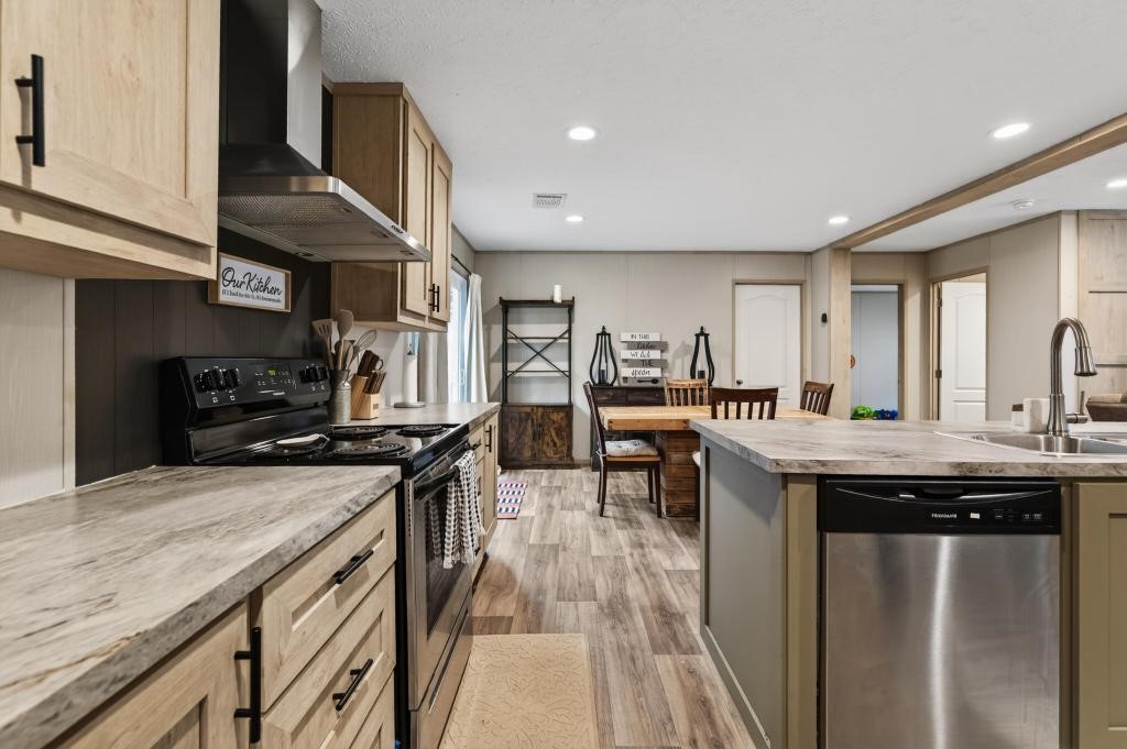 1088 Mulberry Landing Road Hilliard, FL 32046 - Photo 12 of 30 a kitchen with stainless steel appliances granite countertop a stove and a sink