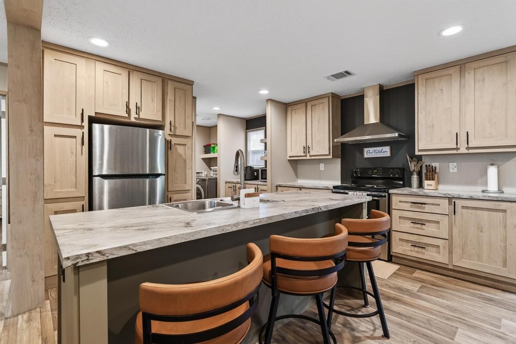 1088 Mulberry Landing Road Hilliard, FL 32046 - Photo 13 of 30 a kitchen with granite countertop a stove a sink dishwasher a refrigerator with a dining table and chairs
