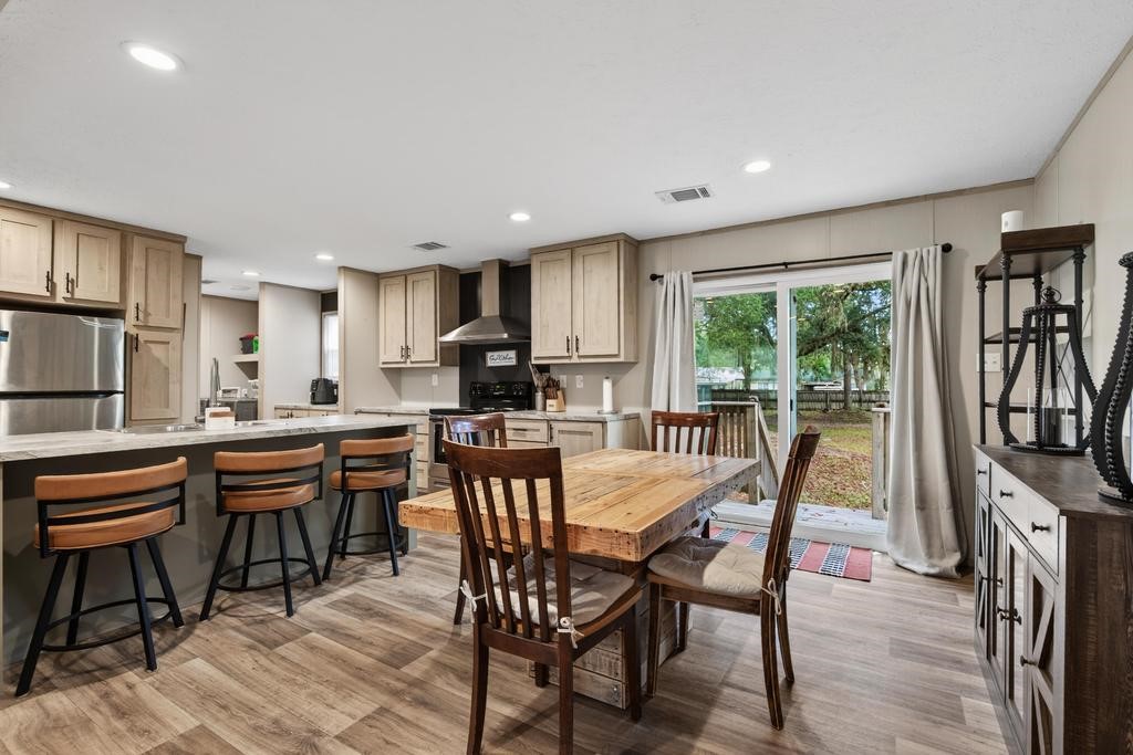 1088 Mulberry Landing Road Hilliard, FL 32046 - Photo 15 of 30 a view of a dining room with furniture window and wooden floor