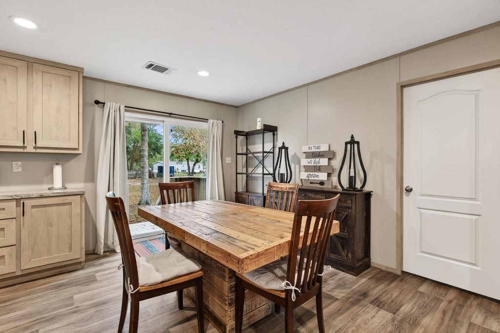 1088 Mulberry Landing Road Hilliard, FL 32046 - Photo 16 of 30 a view of a dining room with furniture and wooden floor
