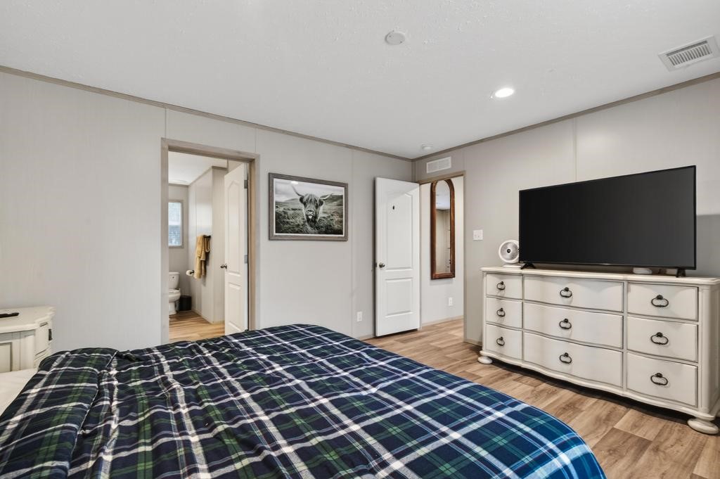 1088 Mulberry Landing Road Hilliard, FL 32046 - Photo 18 of 30 a bedroom with a bed and flat screen tv