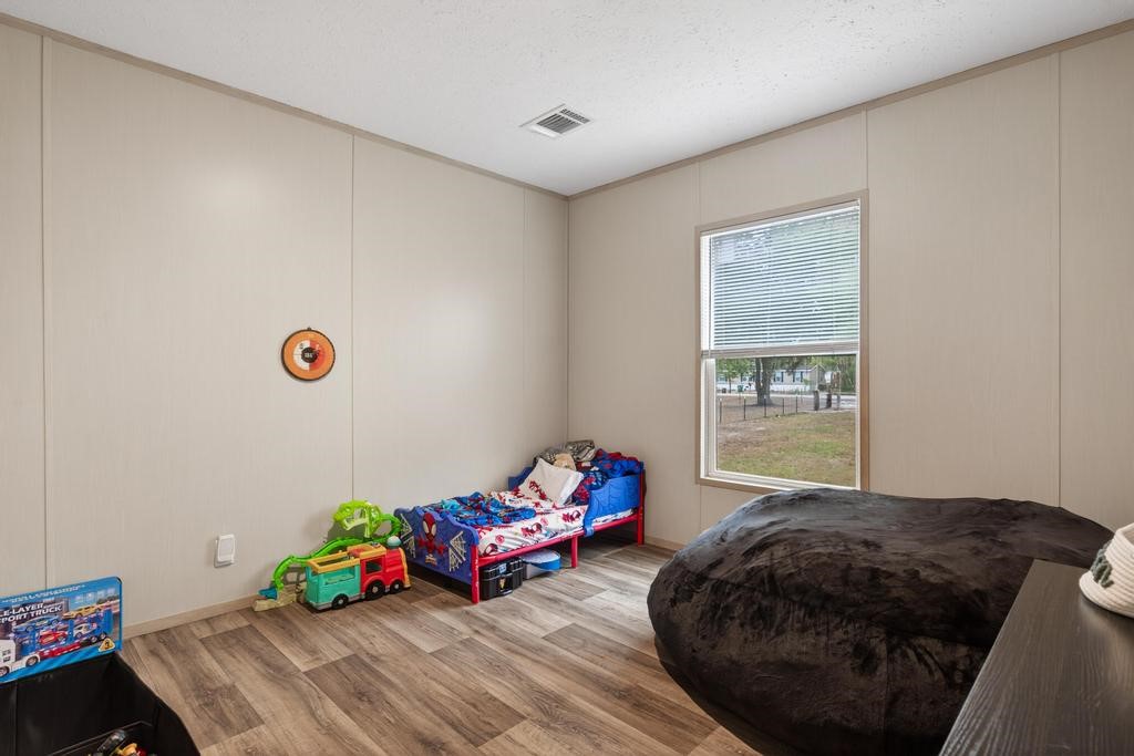 1088 Mulberry Landing Road Hilliard, FL 32046 - Photo 22 of 30 a bedroom with a bed and a window