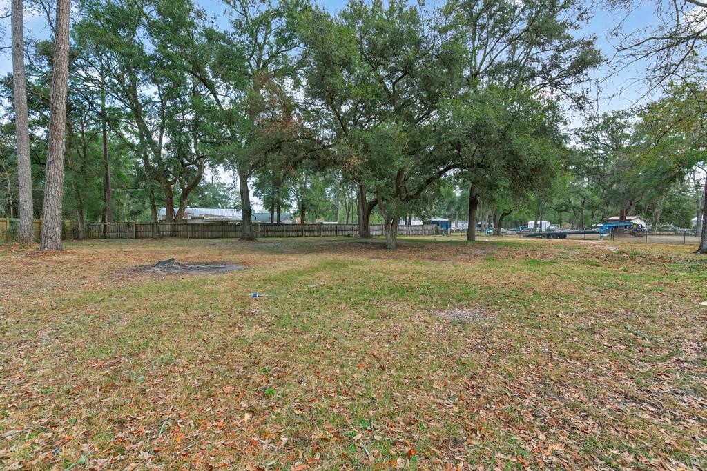 1088 Mulberry Landing Road Hilliard, FL 32046 - Photo 24 of 30 a view of a green field with trees