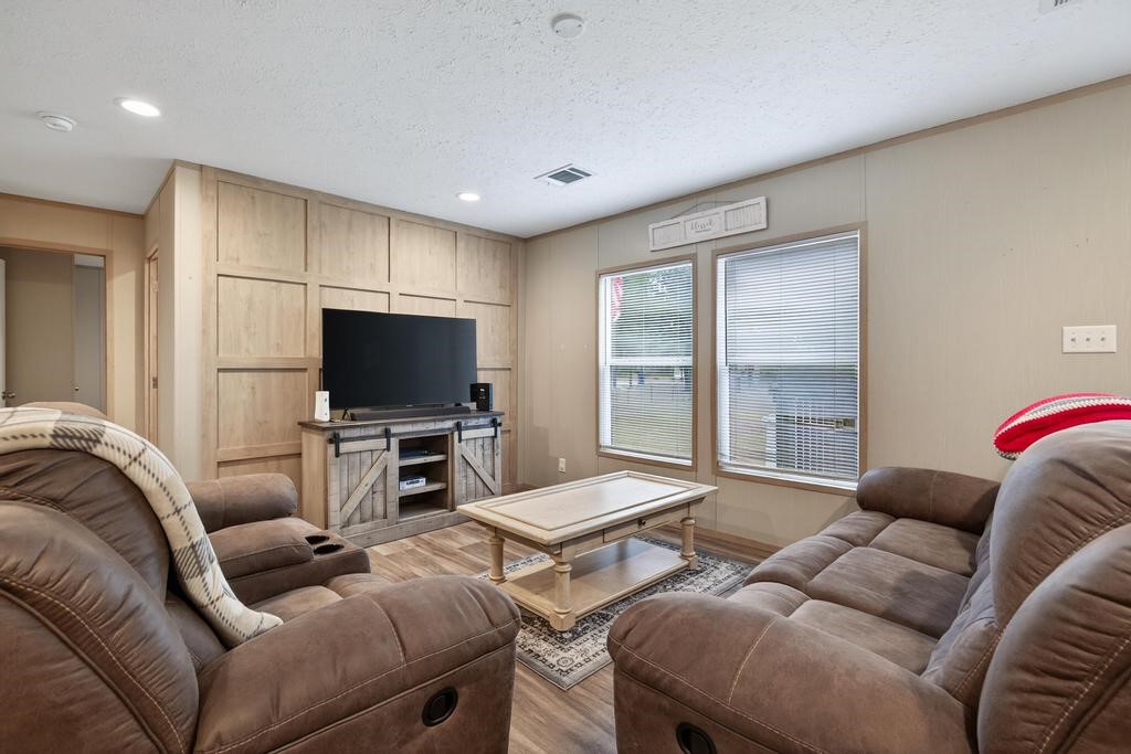 1088 Mulberry Landing Road Hilliard, FL 32046 - Photo 7 of 30 a living room with furniture and a flat screen tv