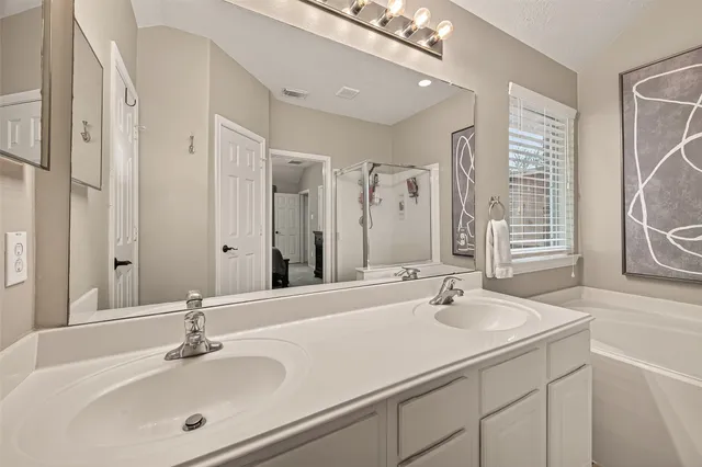 a bathroom with a bathtub and a shower