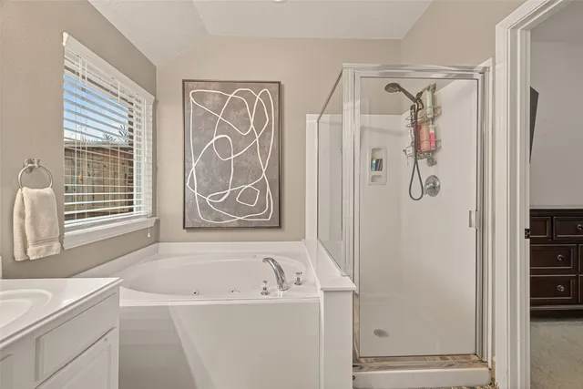 a view of walk in closet with clothes