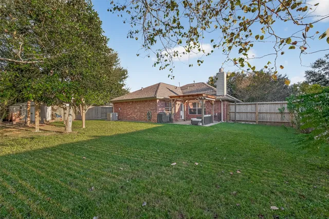 a view of a chair and table in the yard and covered with wooden fence