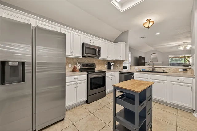 a kitchen with a refrigerator stove and microwave