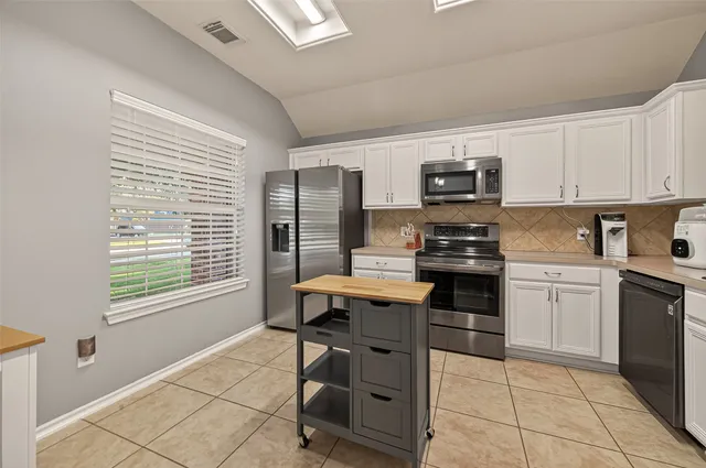 a kitchen with a stove a sink and a refrigerator