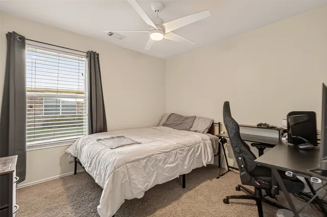 a bedroom with a bed and a desk