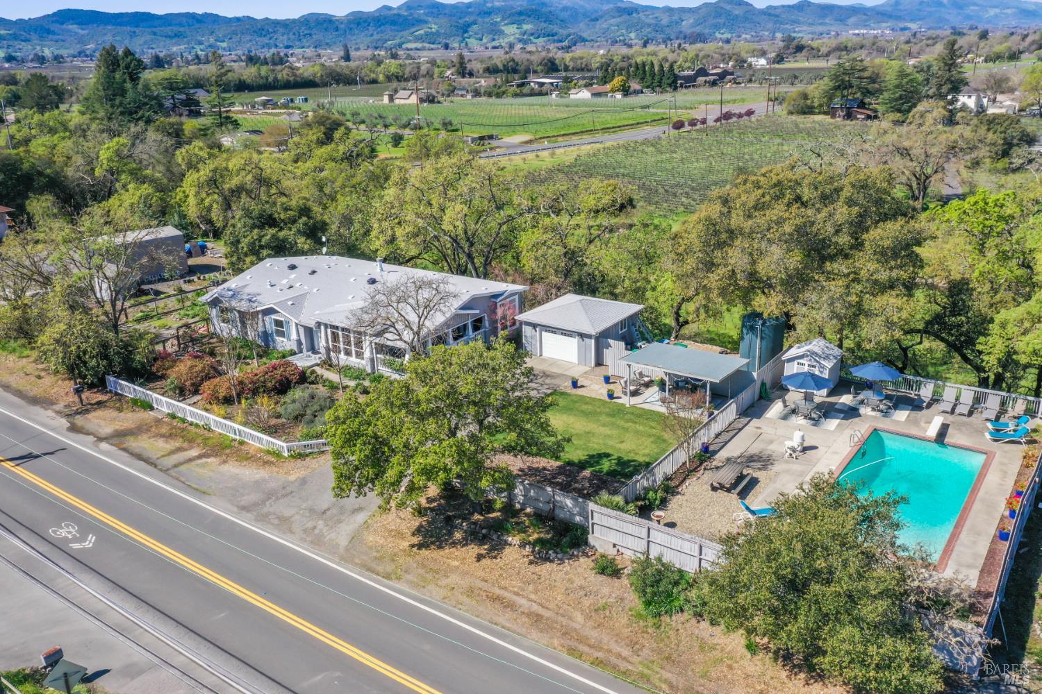 an aerial view of a house with garden space and outdoor seating