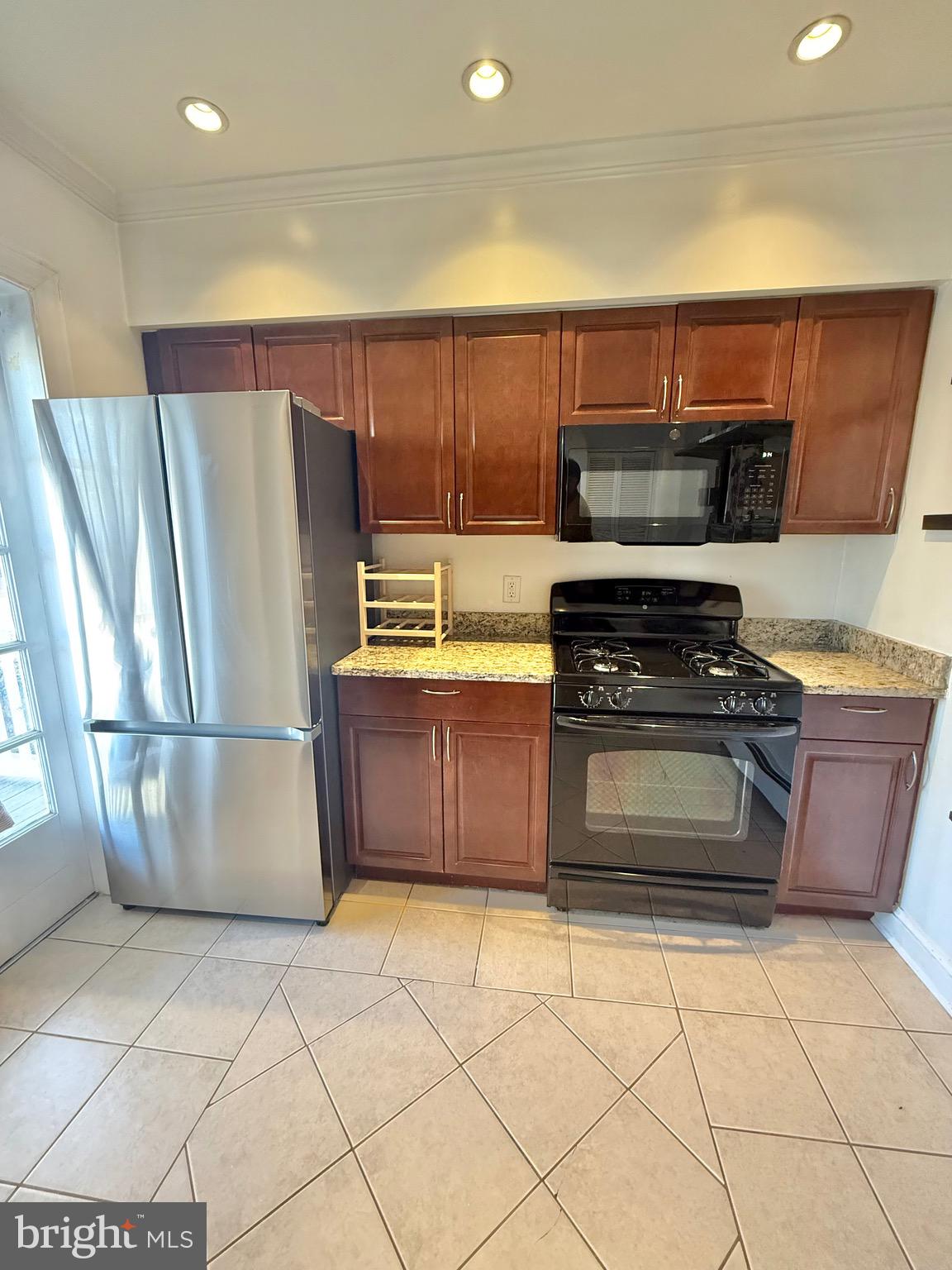 718 Oronoco Street, Unit 2 Alexandria, VA 22314 - Photo 14 of 27 a kitchen with granite countertop a refrigerator and a stove top oven