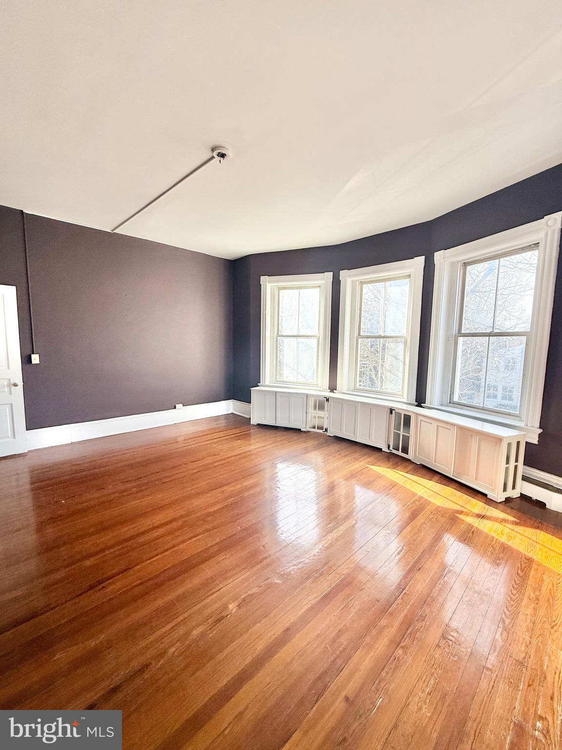 718 Oronoco Street, Unit 2 Alexandria, VA 22314 - Photo 4 of 27 a view of an empty room with window and wooden floor