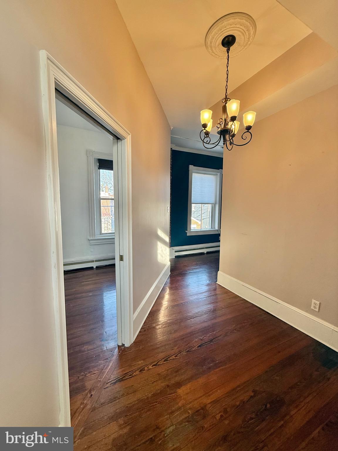 718 Oronoco Street, Unit 2 Alexandria, VA 22314 - Photo 7 of 27 a view of a room with wooden floor and chandelier