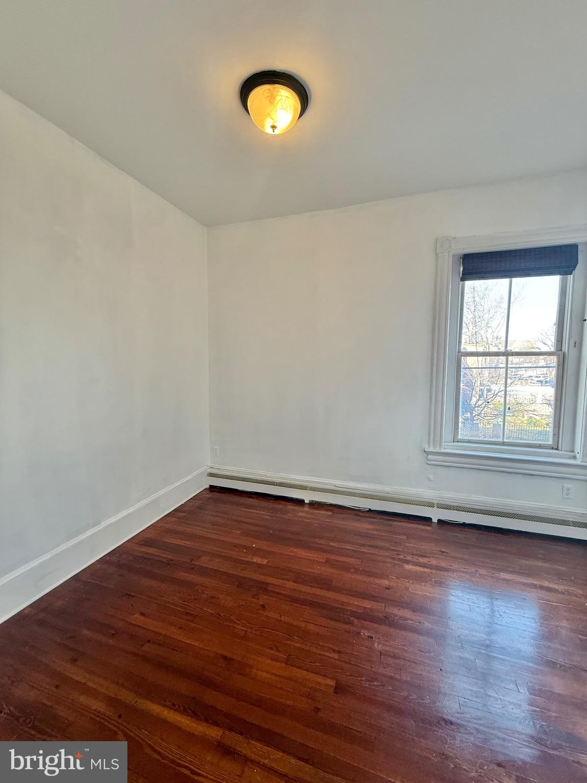 718 Oronoco Street, Unit 2 Alexandria, VA 22314 - Photo 8 of 27 wooden floor in an empty room with a window