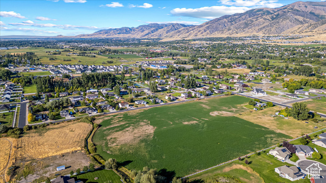 294 West 3400 South, Unit 9 Logan, UT 84321 - Photo 16 of 24 Aerial overview of property's location with mountains and nearby suburban area