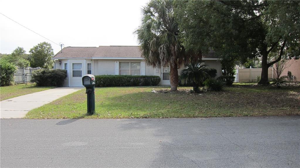 11120 Blythville Road Spring Hill, FL 34608 - Photo 1 of 1 a front view of a house with a yard and tree