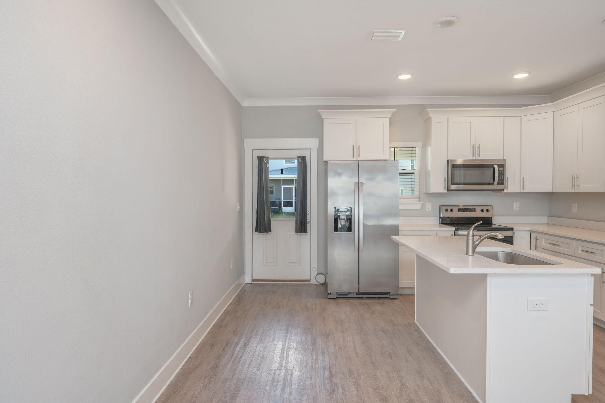 147 North Sand Palm Road Freeport, FL 32439 - Photo 11 of 39 a kitchen with a refrigerator a sink and cabinets