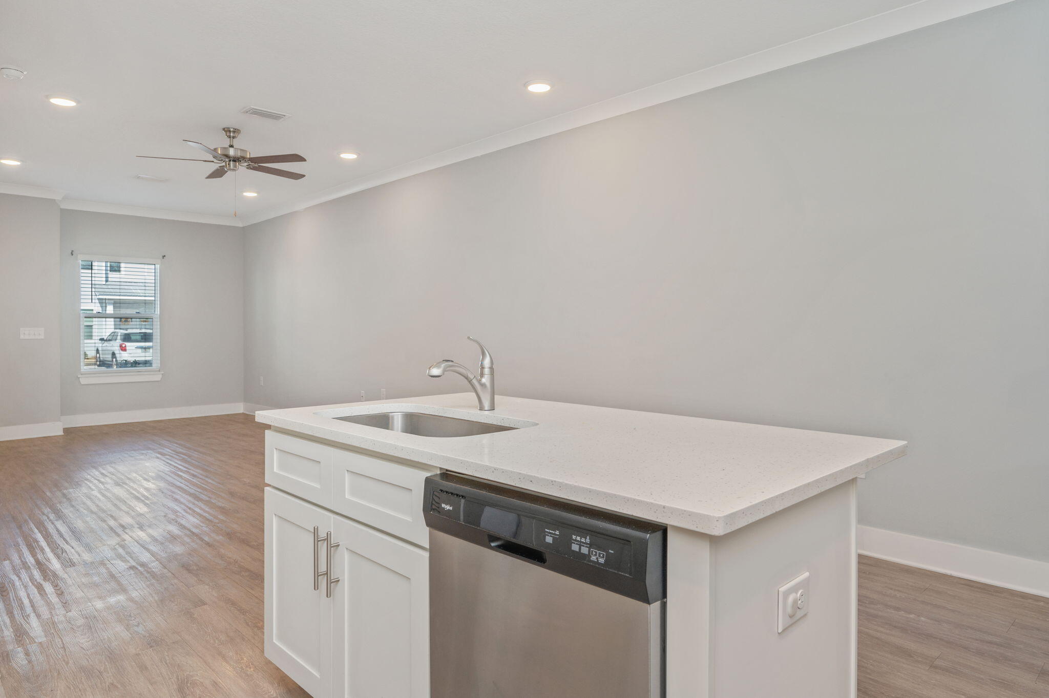 147 North Sand Palm Road Freeport, FL 32439 - Photo 13 of 39 a view of a kitchen island the sink wooden floor and a window