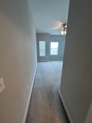 a view of a hallway with windows