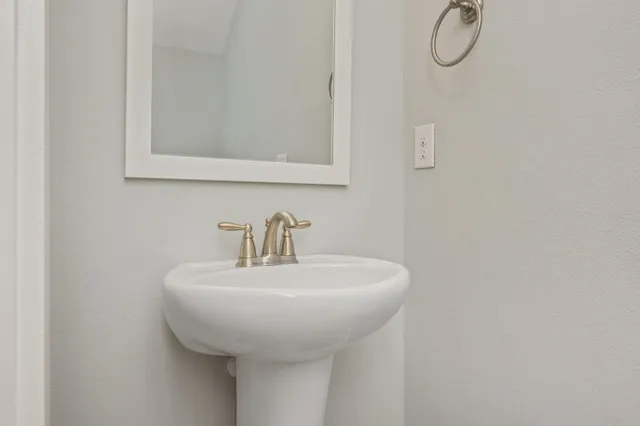 a white toilet sitting next to a white tub
